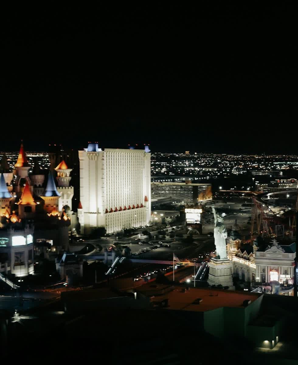 The Las Vegas Strip at night, including a hot-air-balloon marquee, with no readable hotel name.