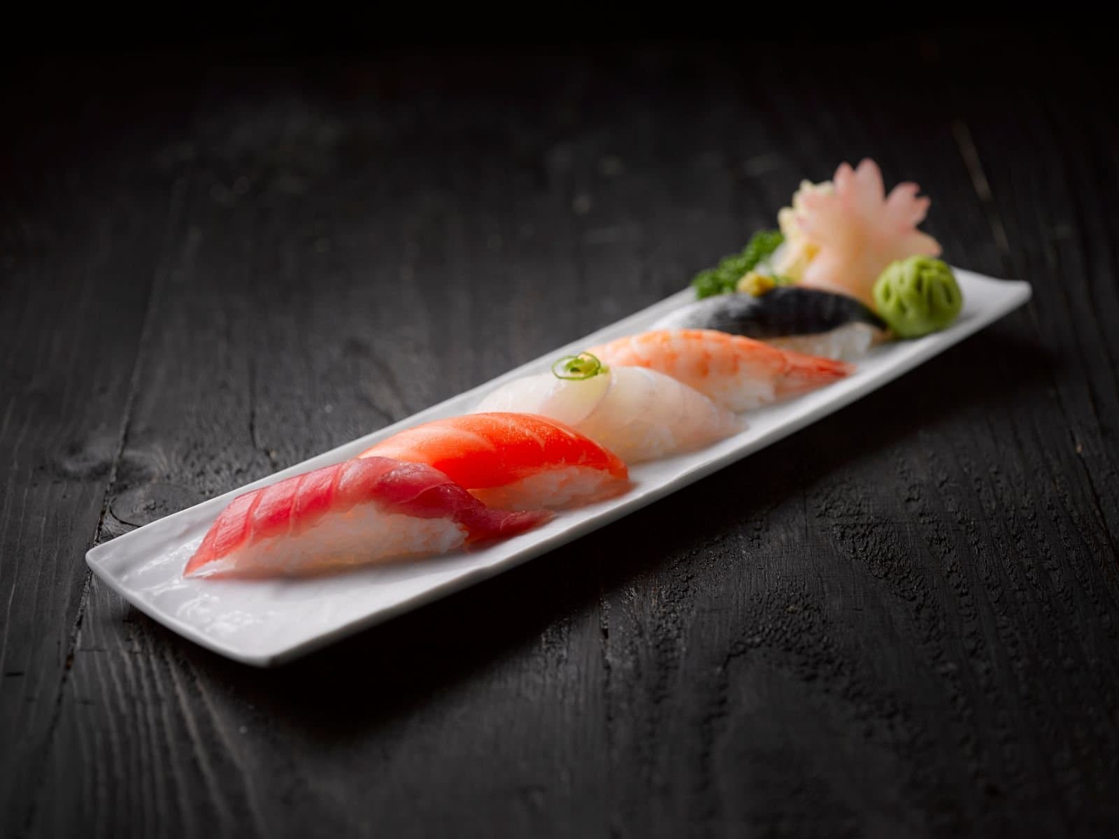 Sushi platter on a dark wood table, a casino comp meal