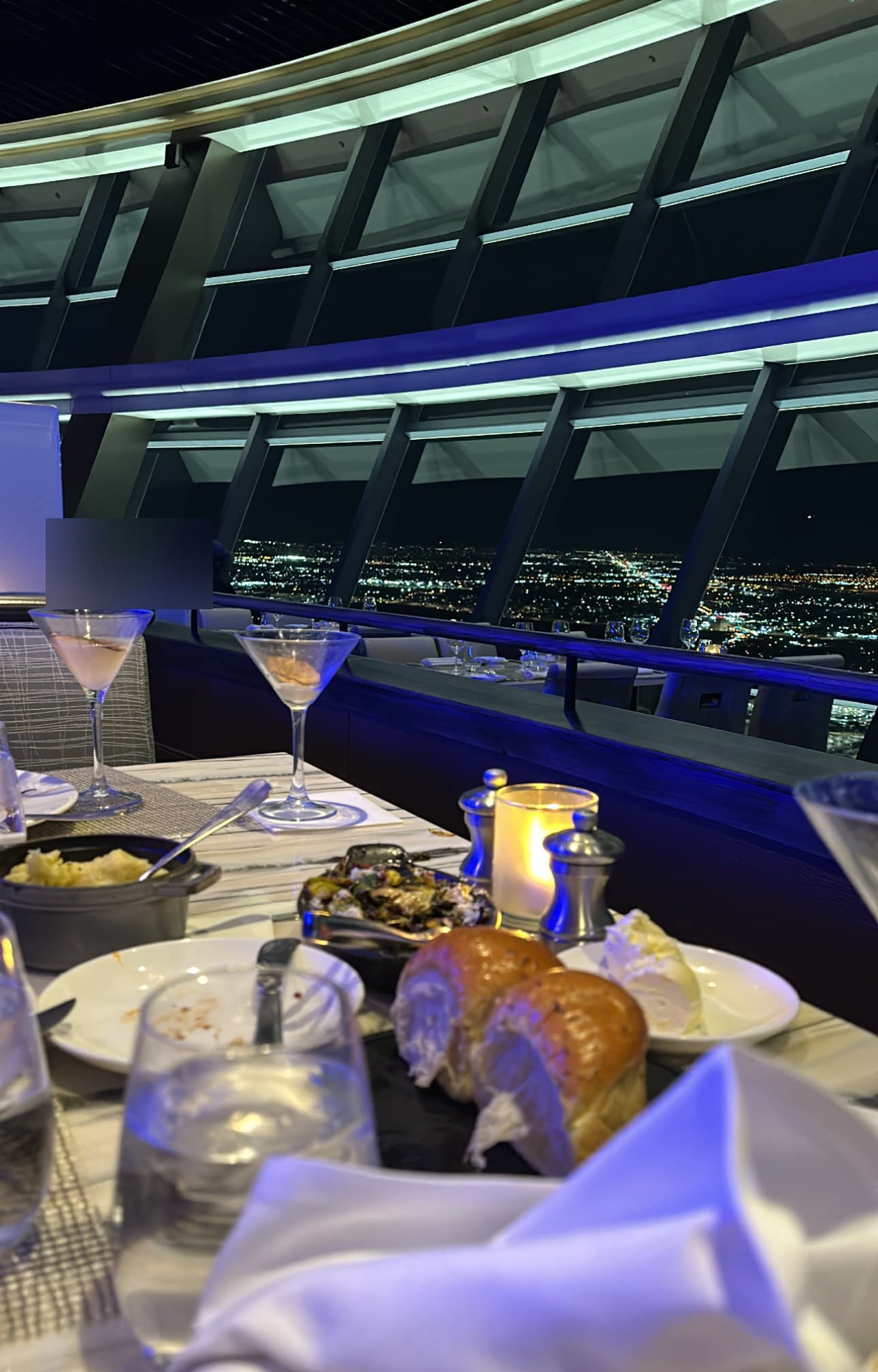 Plated dinner beside a nighttime city skyline, a casino comp view